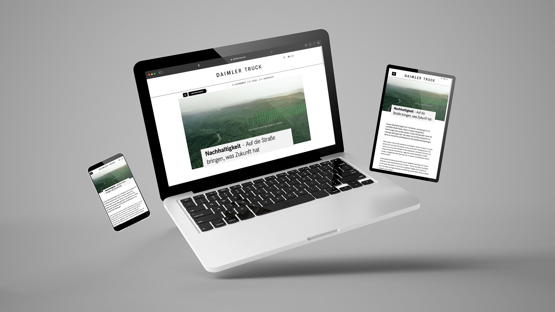 Laptop, Tablet und Handy mit der Daimler Truck Website auf dem Bildschirm